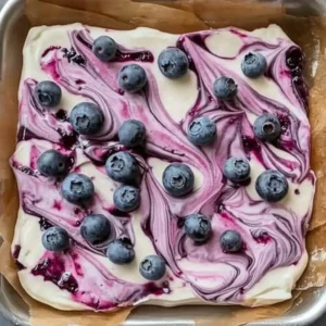 Blueberry cheesecake yogurt bark topped with fresh blueberries